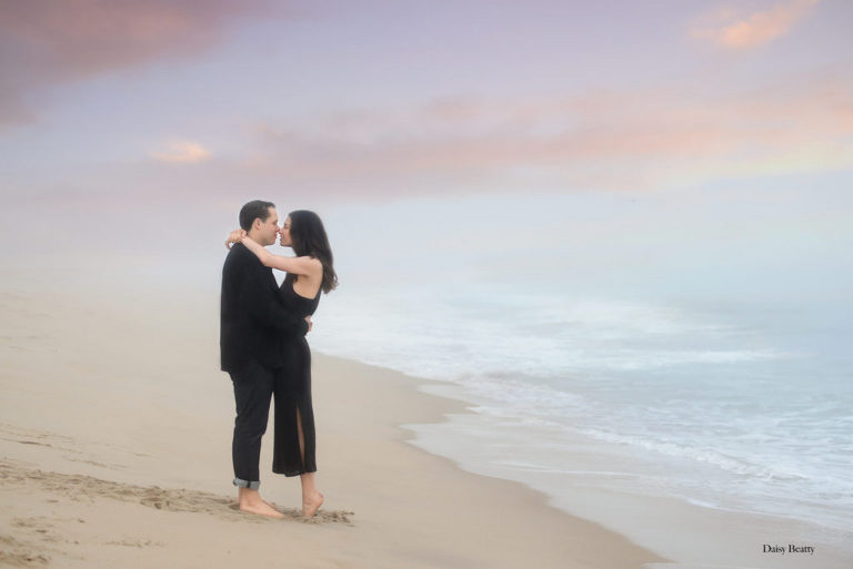 engagement photos at sunset on a beach in east hampton ny by daisy beatty photography