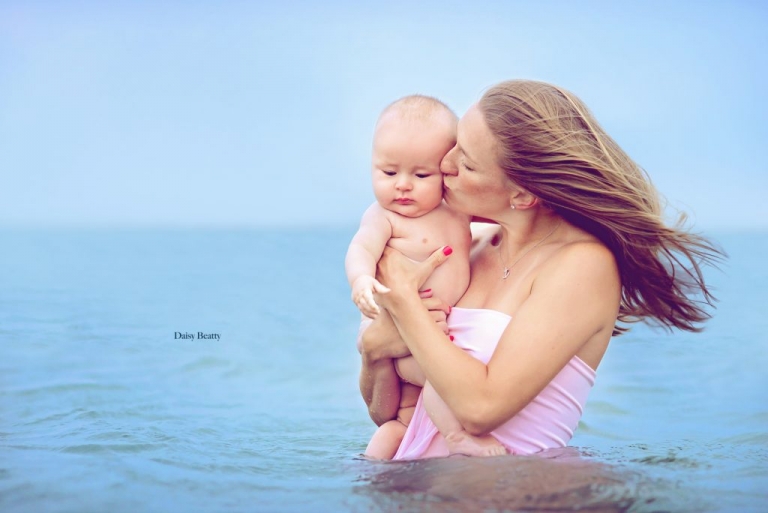 portrait of a mother and baby in the water in east hampton by nyc family photographer daisy beatty