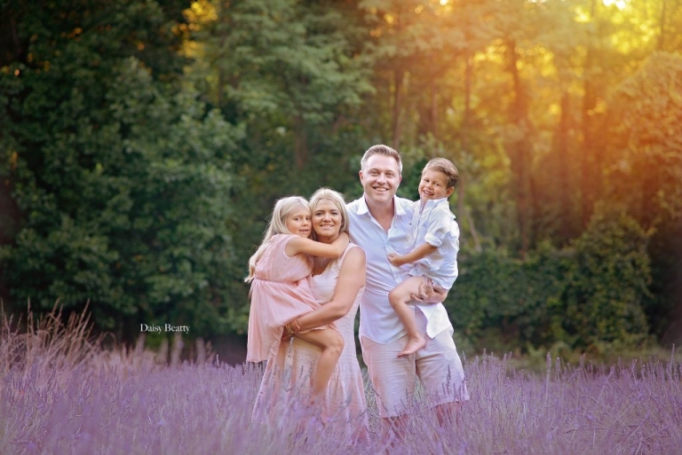 a family in a lavendar field at sunset by daisy beatty photography